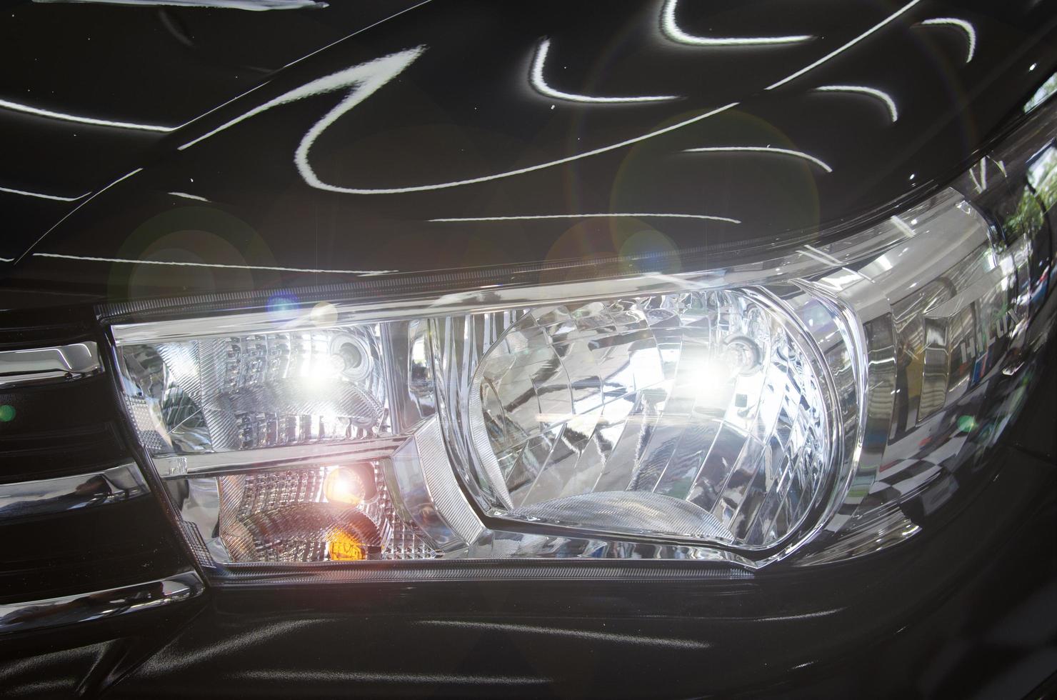 Headlight of a black car photo