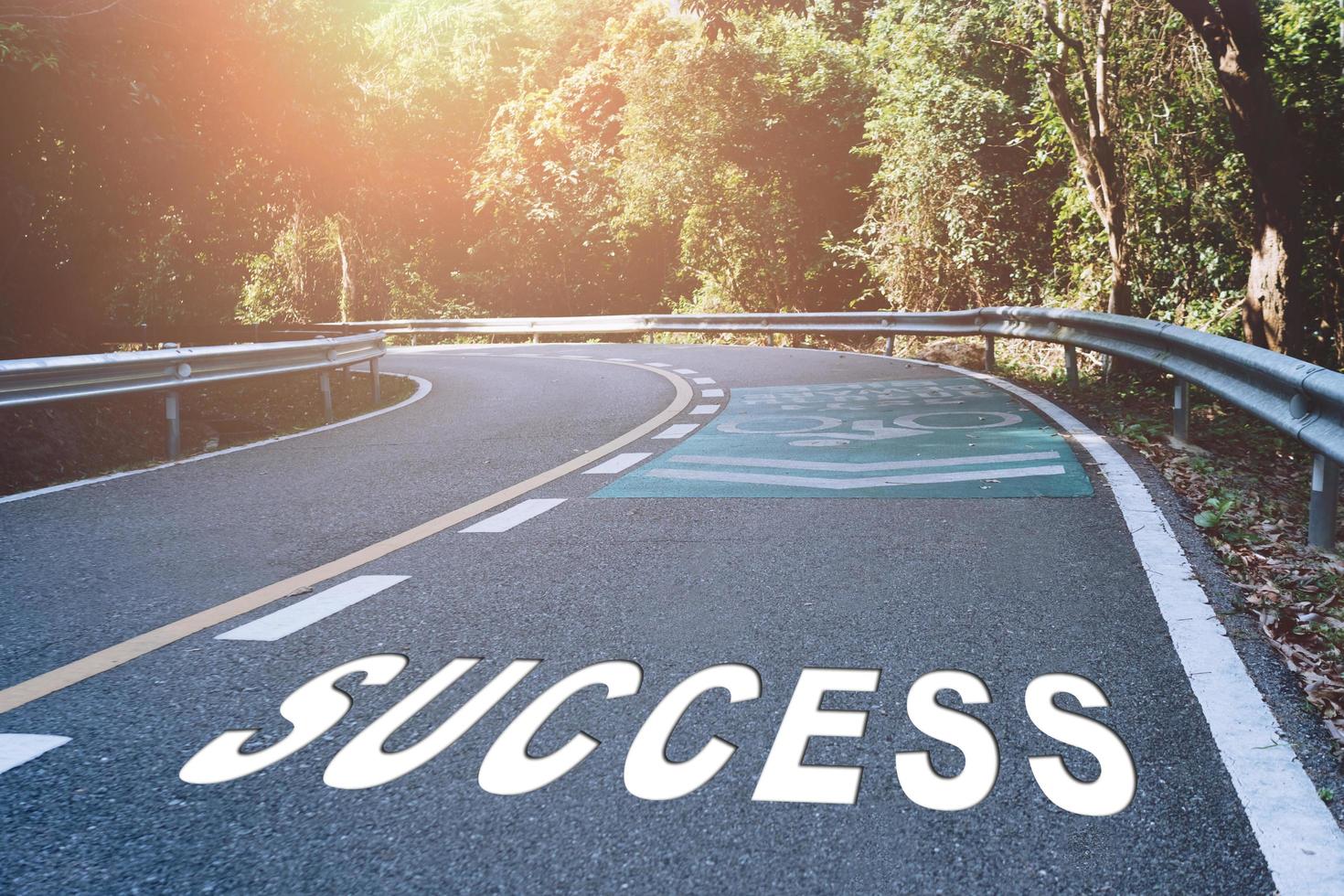 Success word on road represents the beginning of a journey to the destination photo