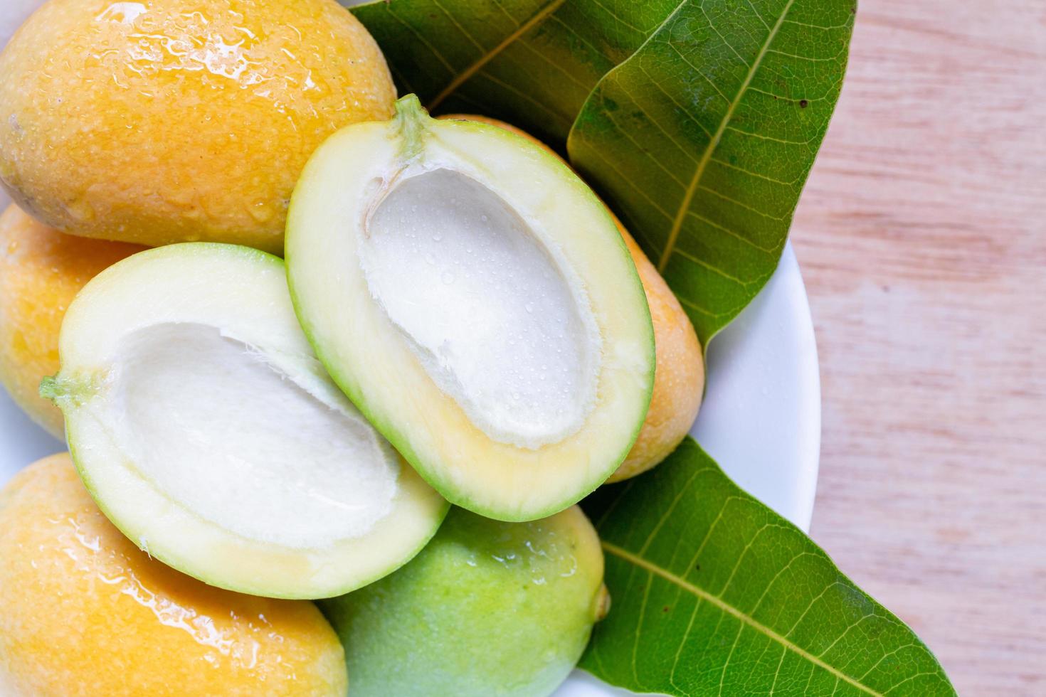 Close up of wild mangoes on a wooden background photo