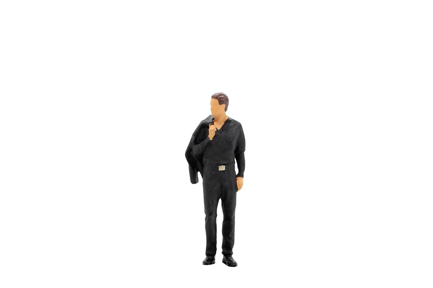 Miniature businessman standing isolated on a white background photo