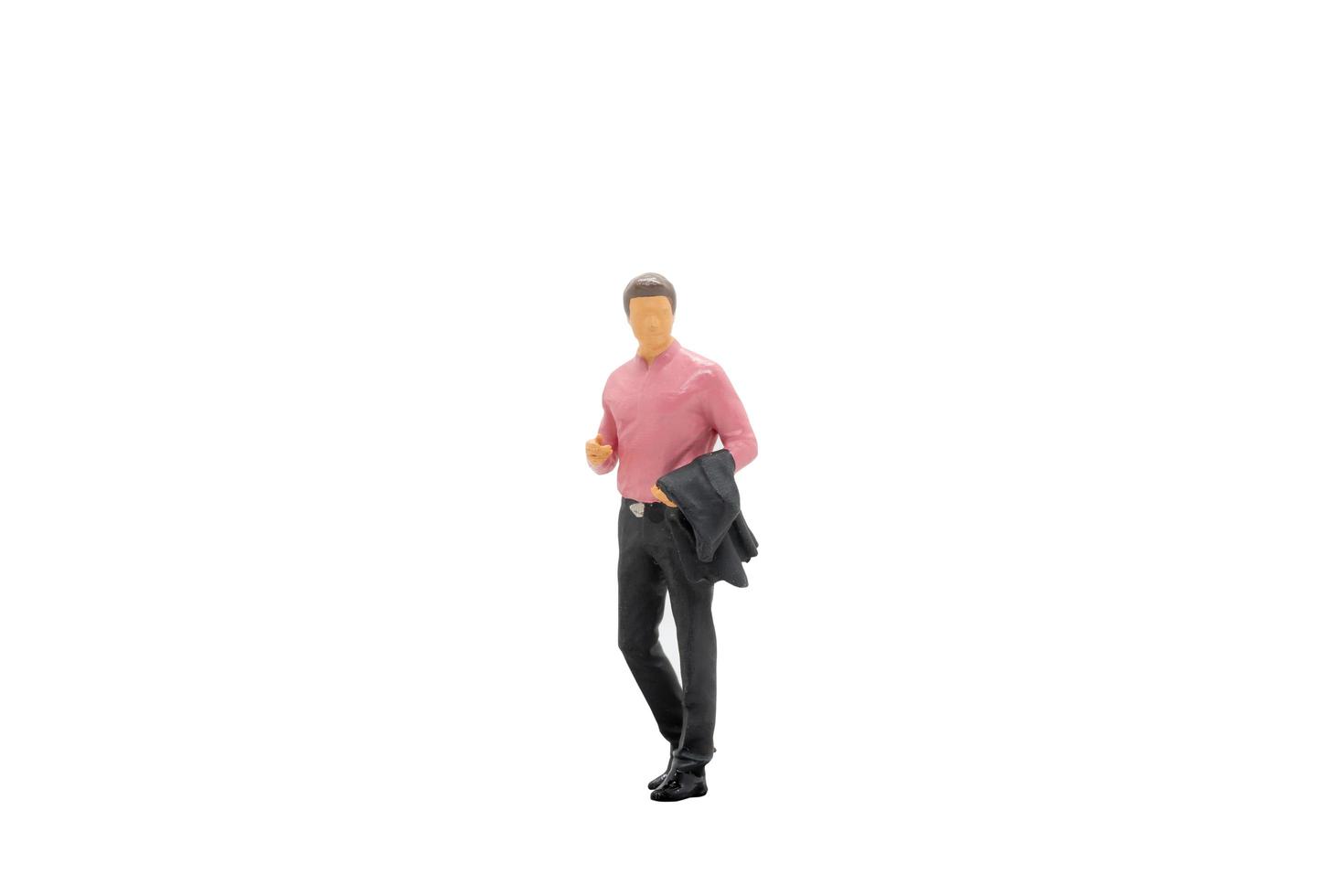 Miniature businessman standing isolated on a white background photo