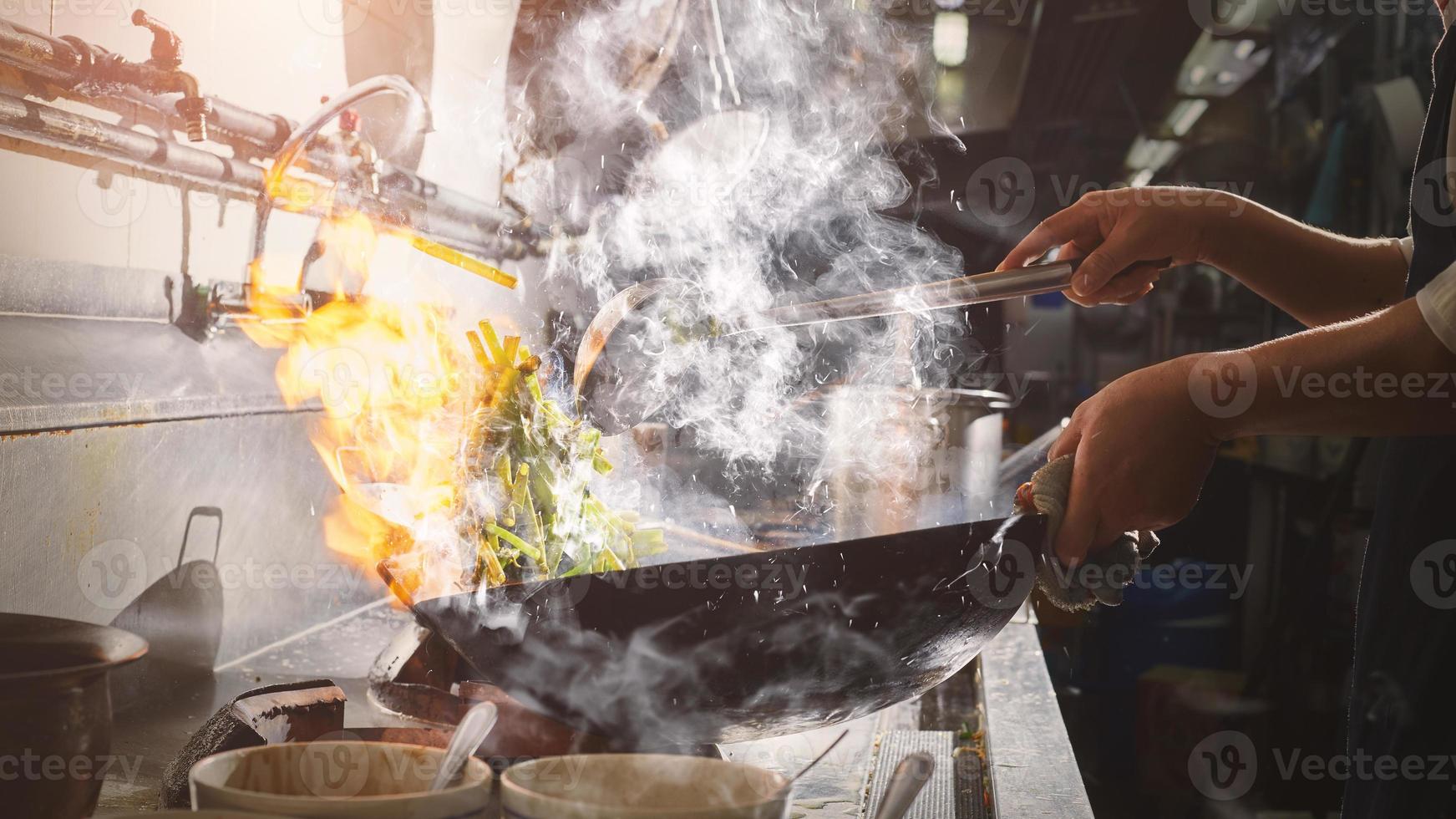 Chef stir-frying in the kitchen photo