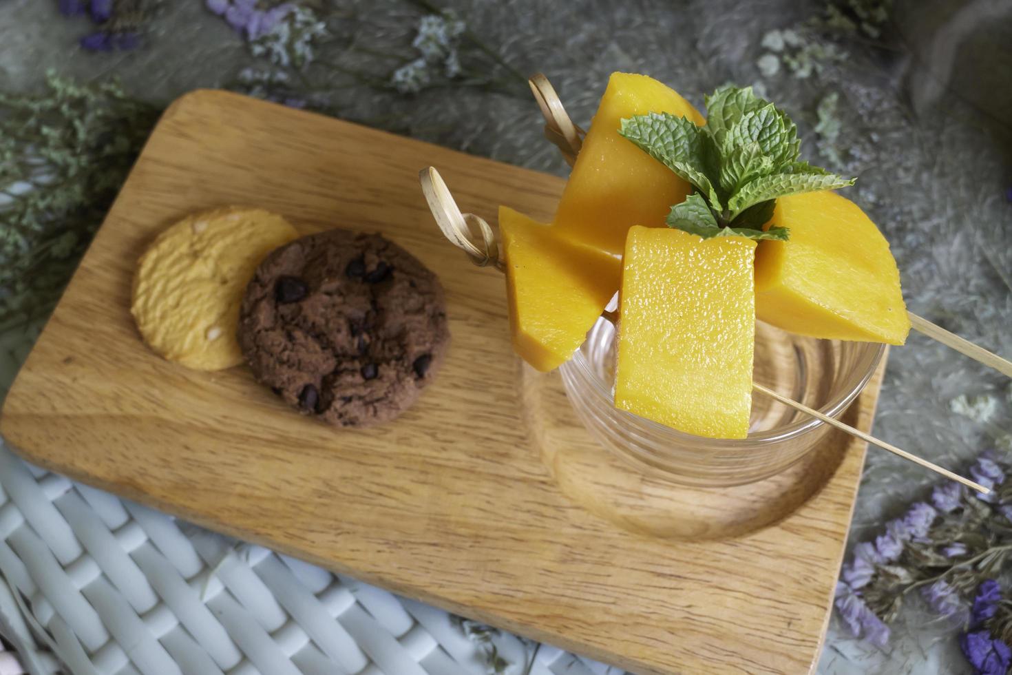 Yellow mango with cookies photo