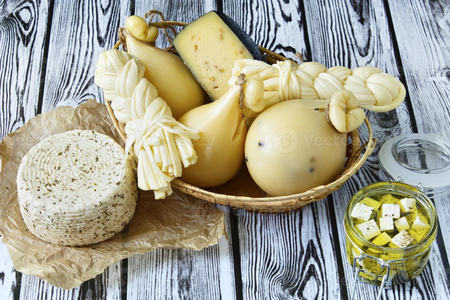 Different types of cheeses on a wooden background photo