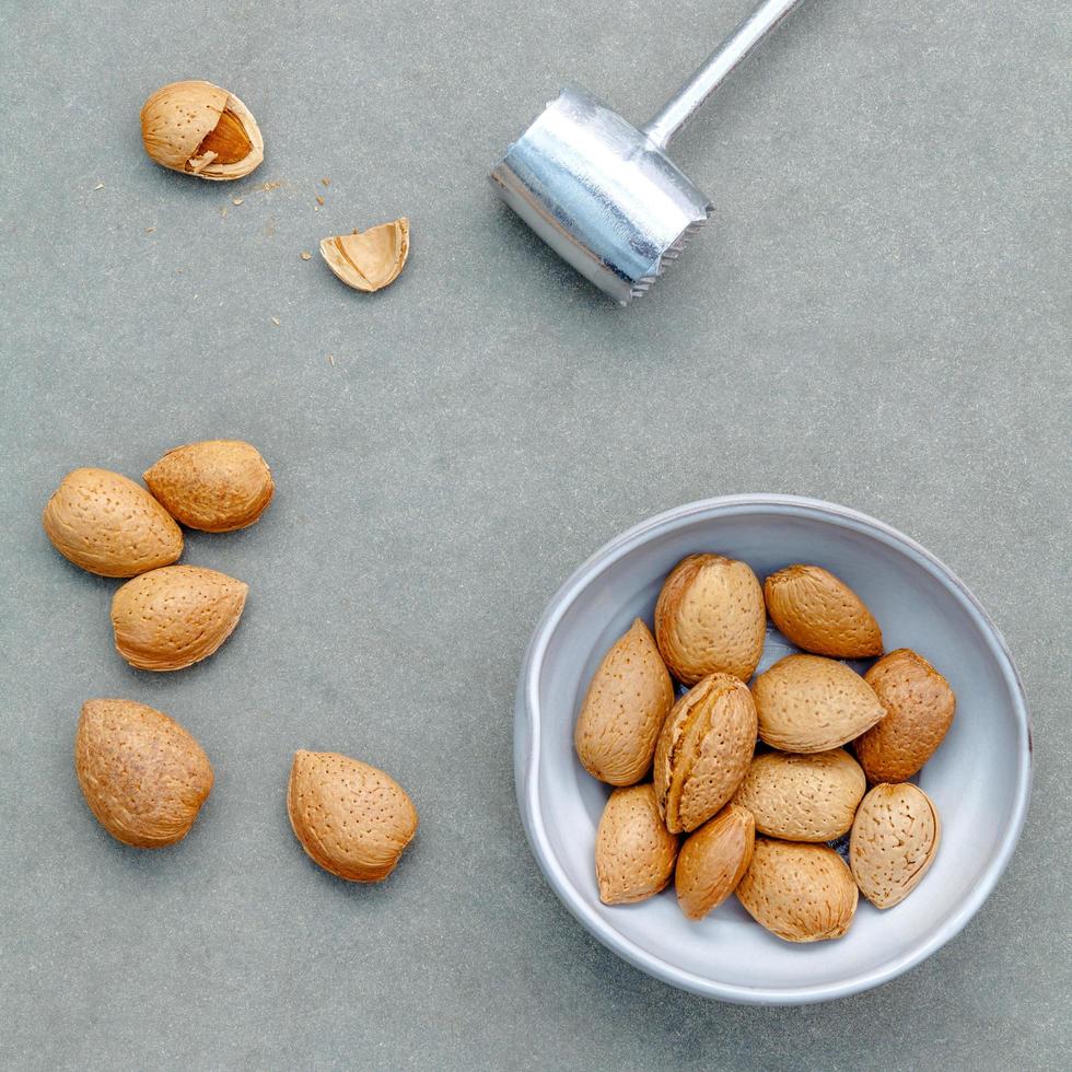 Almonds and nutcracker flat lay photo