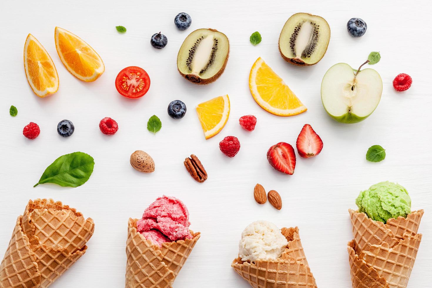 Fruit and nuts with ice cream on white background photo