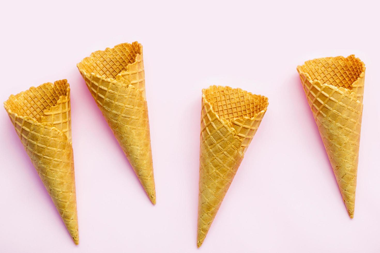 Waffle cones on a pink background photo