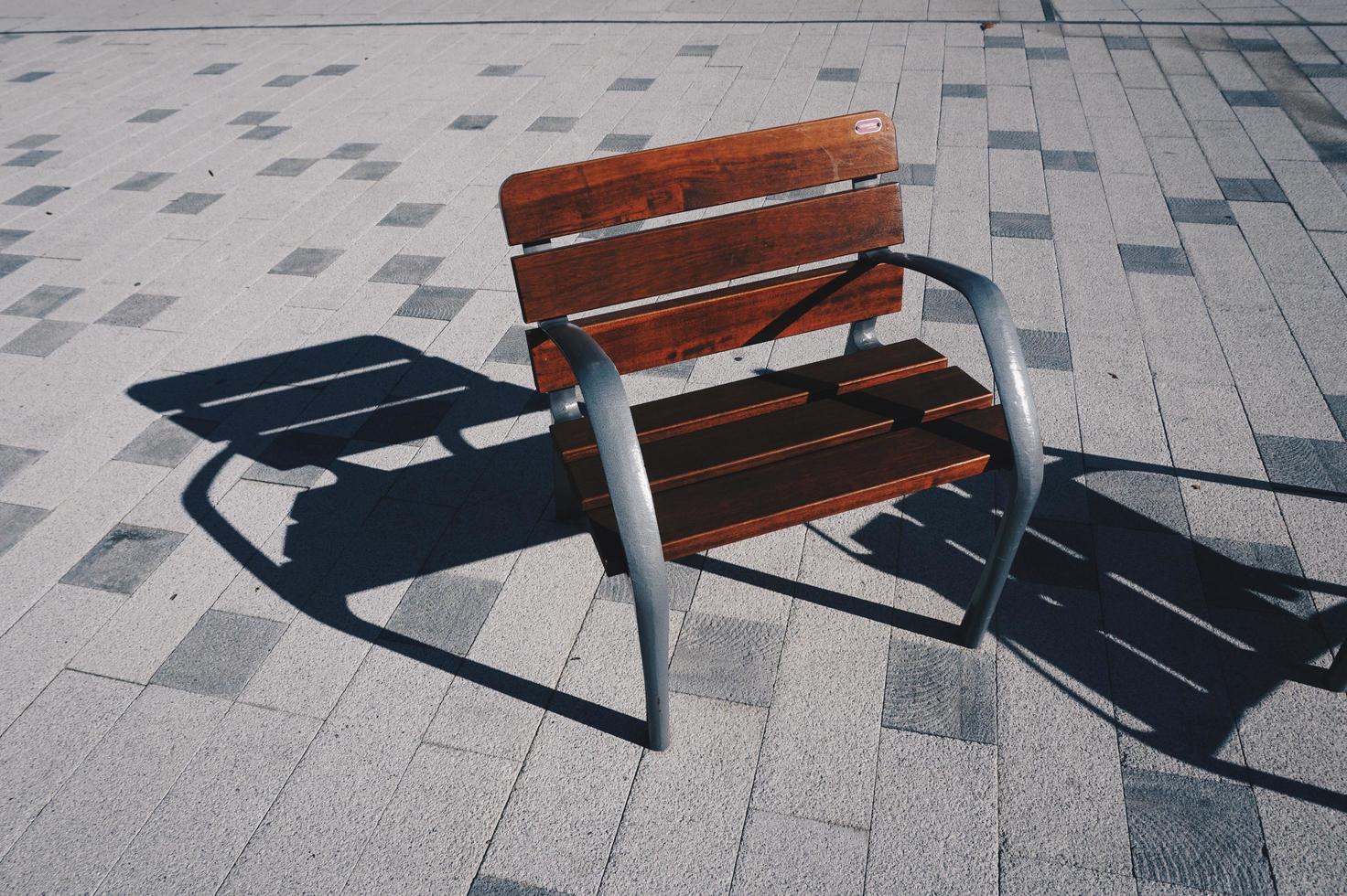 Wooden bench on the street photo