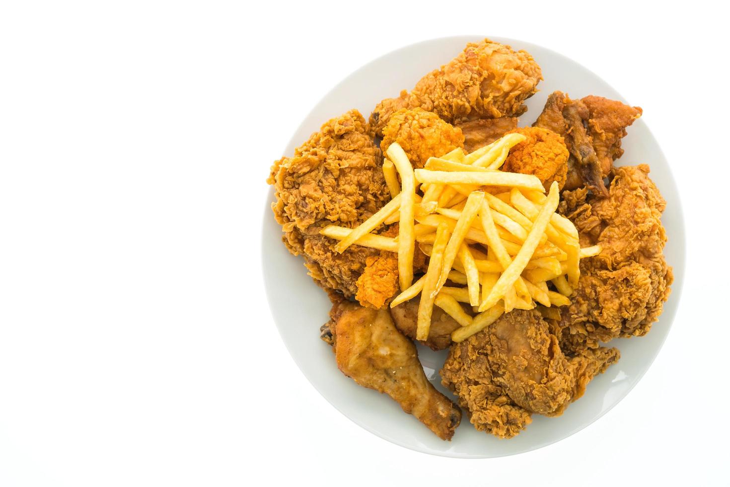 Fried chicken and french fries on a white plate photo