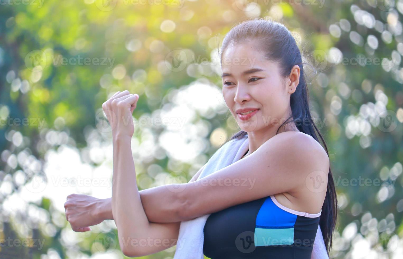 Beautiful woman exercises outdoors in the park photo