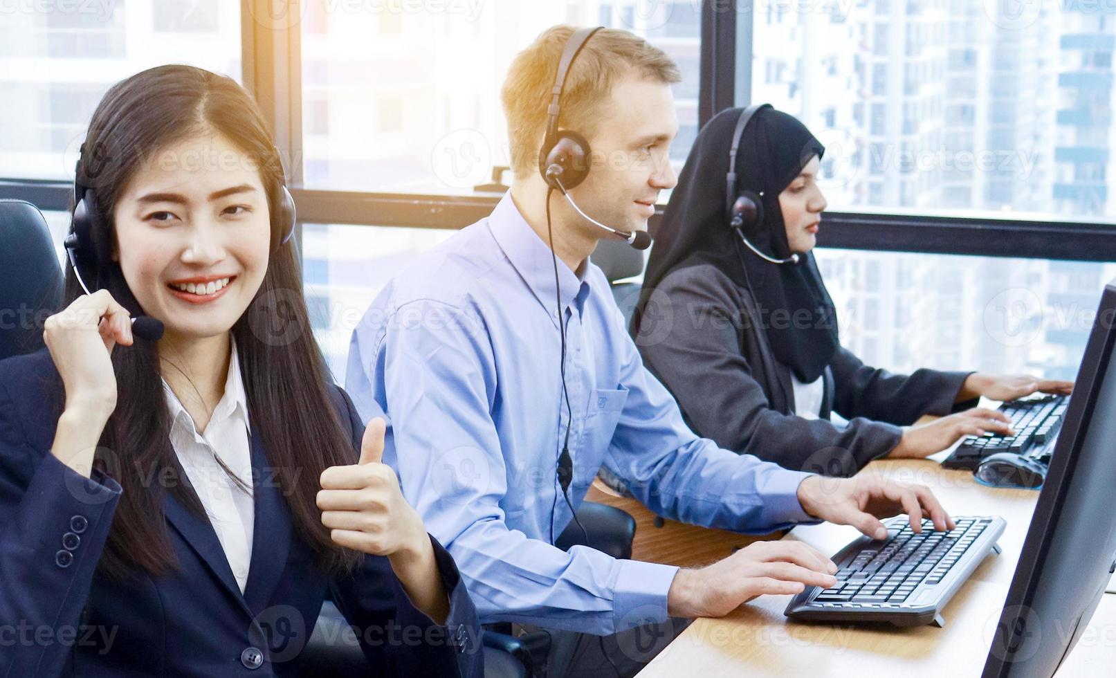 Group call center workers in a modern office photo