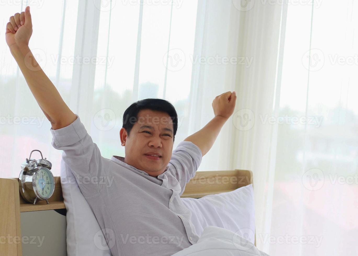 Young Asian man wakes up in the morning refreshed photo