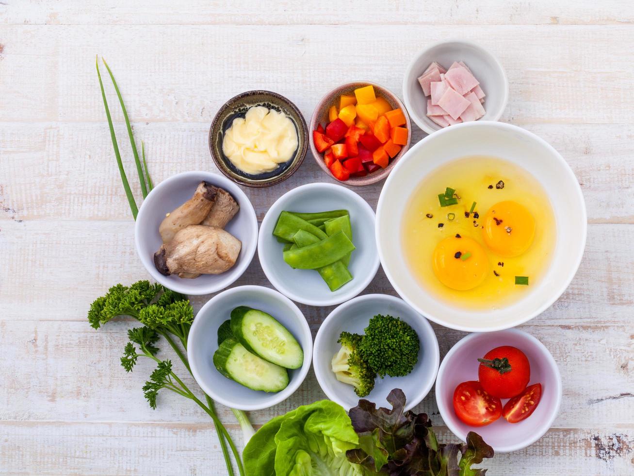 Fresh omelet ingredients in bowls photo