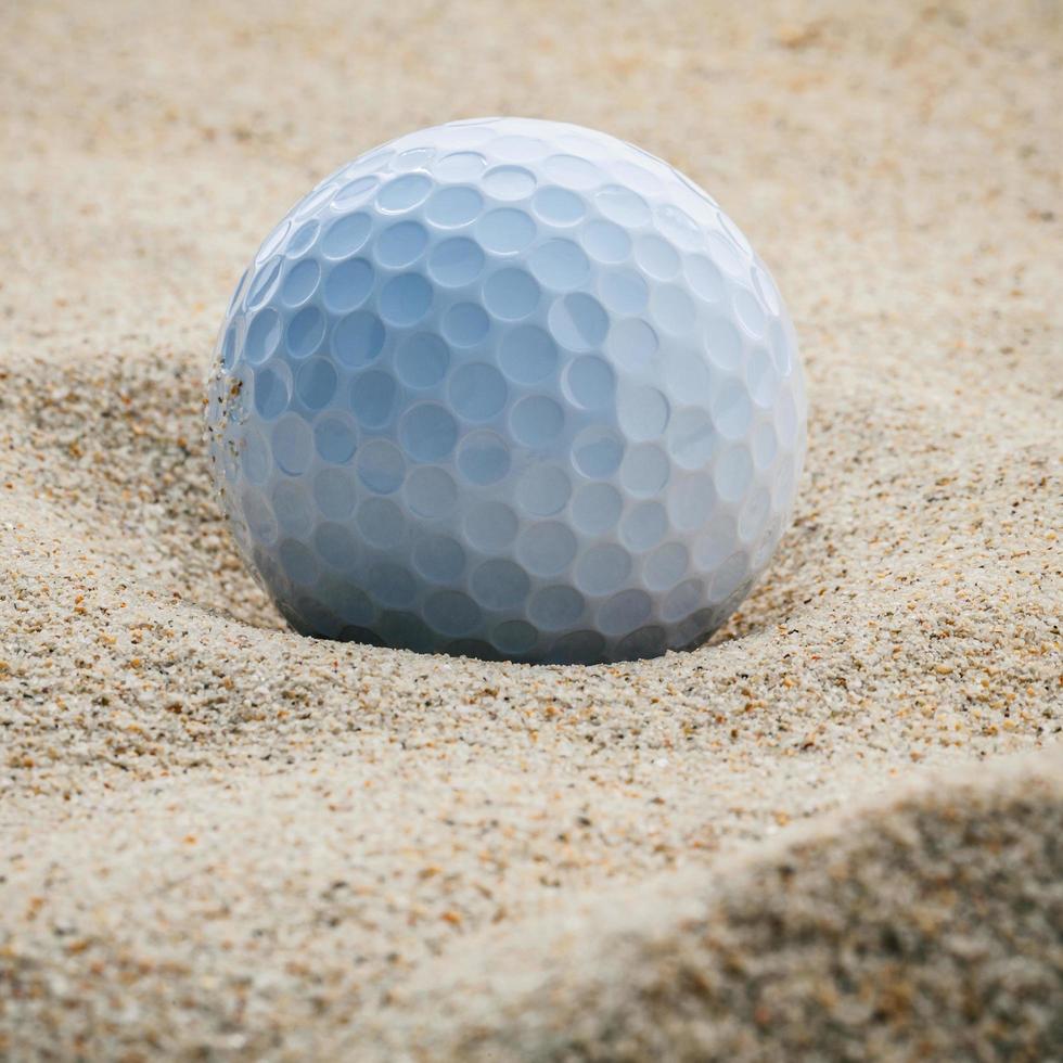 Gold ball in sand photo