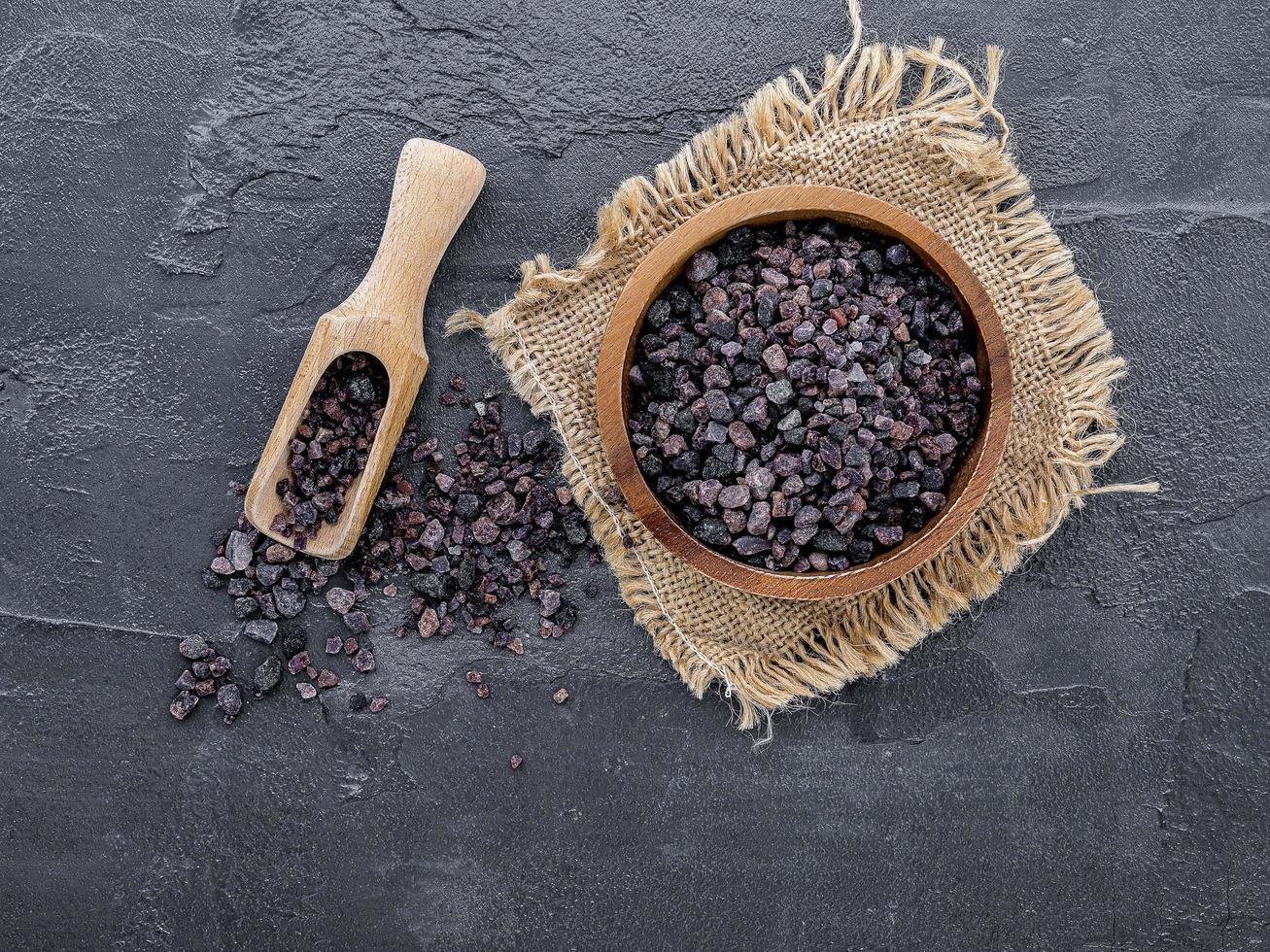 Himalayan black salt on a dark concrete background photo