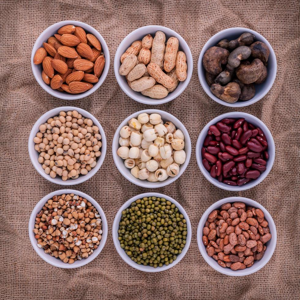 Top view of beans and lentils in bowls photo