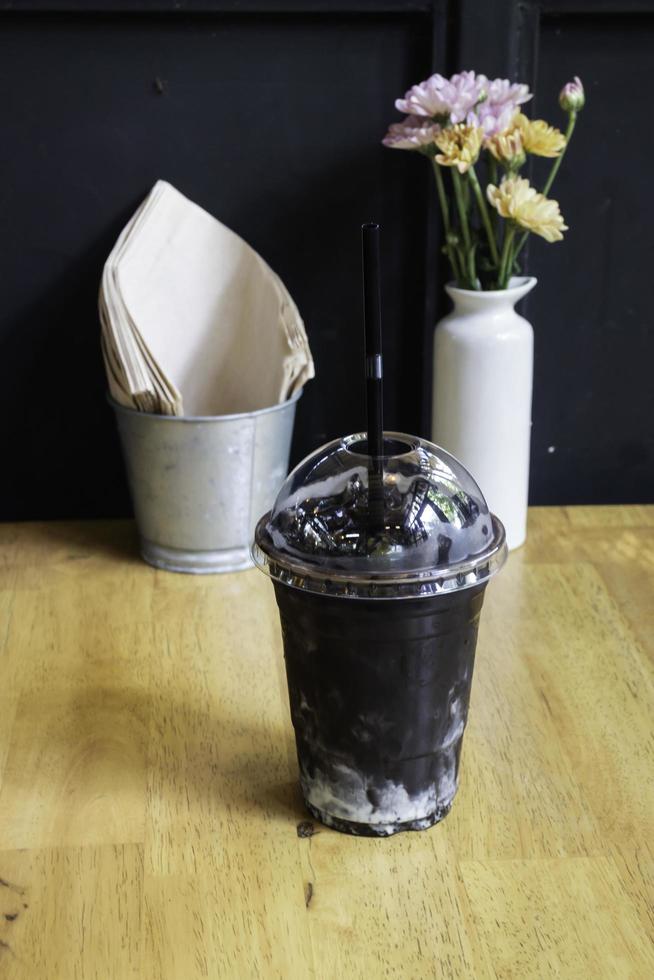 Chocolate iced coffee drink on wooden cafe table photo