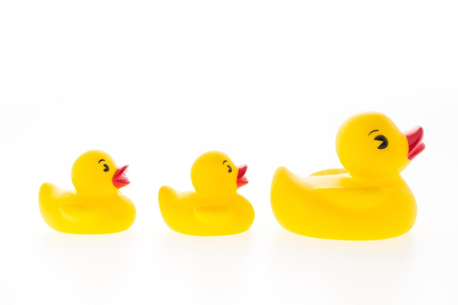 Yellow rubber ducks on white background photo