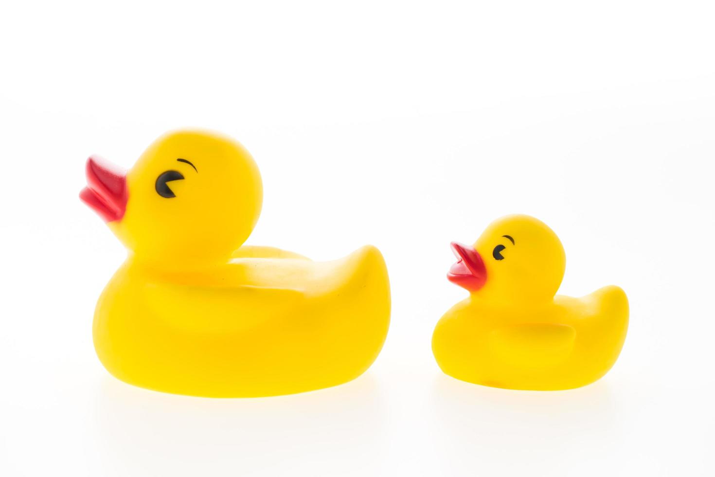 Yellow rubber ducks on white background photo