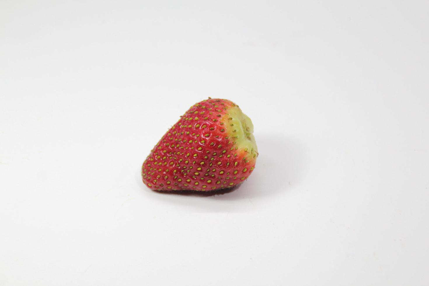 Single strawberry on a white background photo