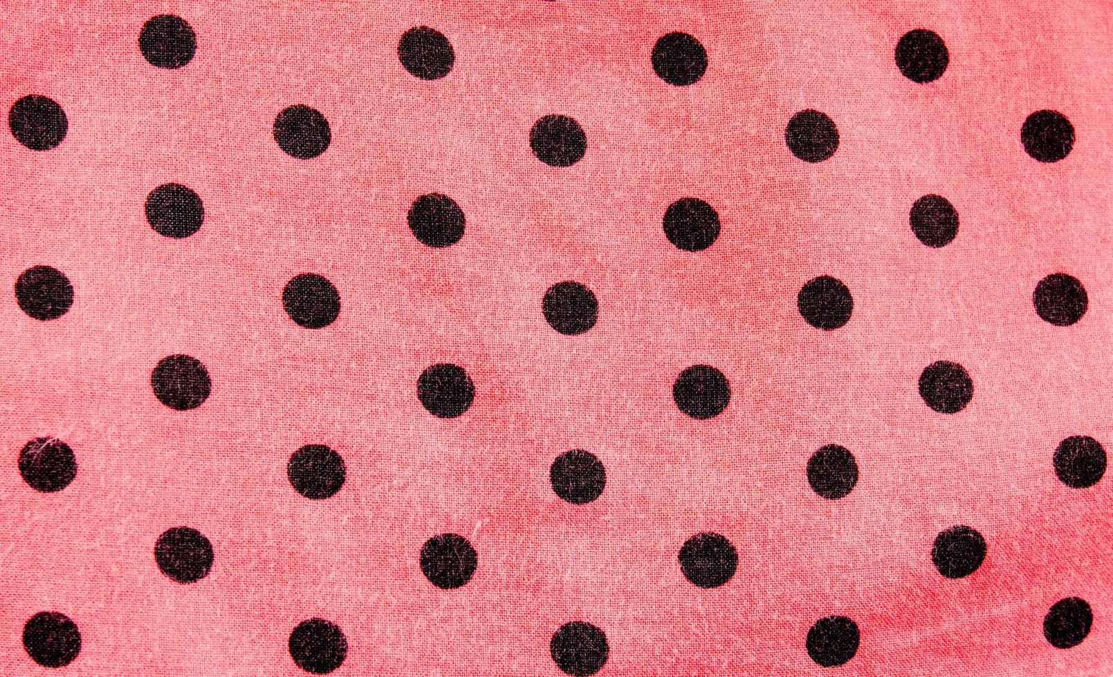 Pink and black polka dot background photo