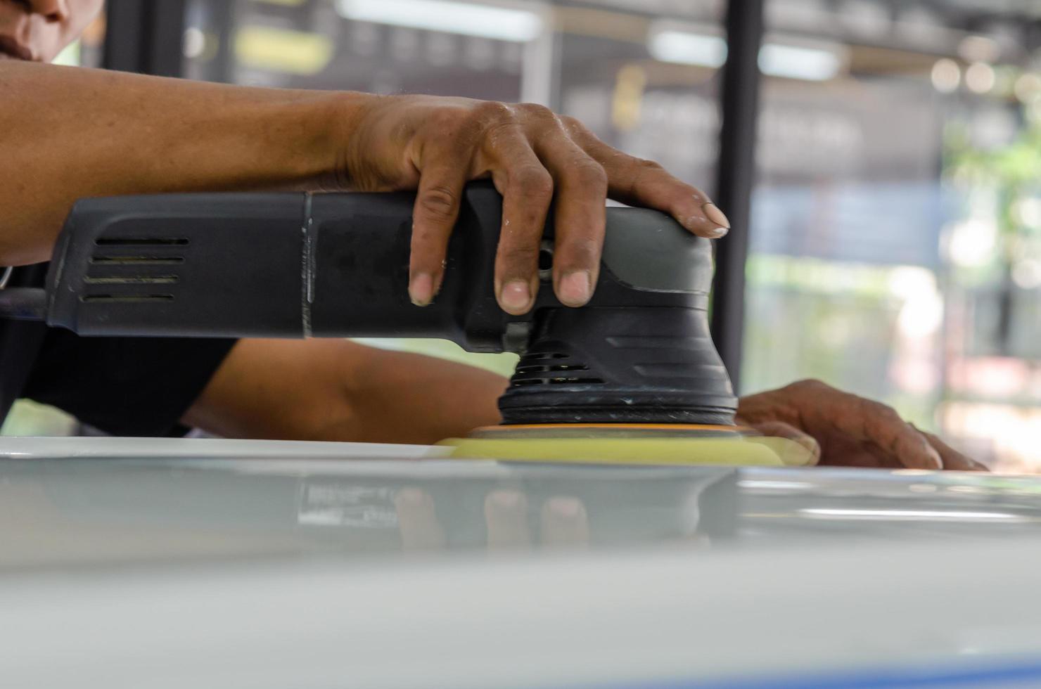 Person polishing car wax photo