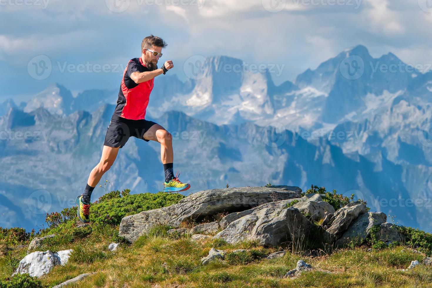 A skyrunner athlete man trains in the high mountains photo