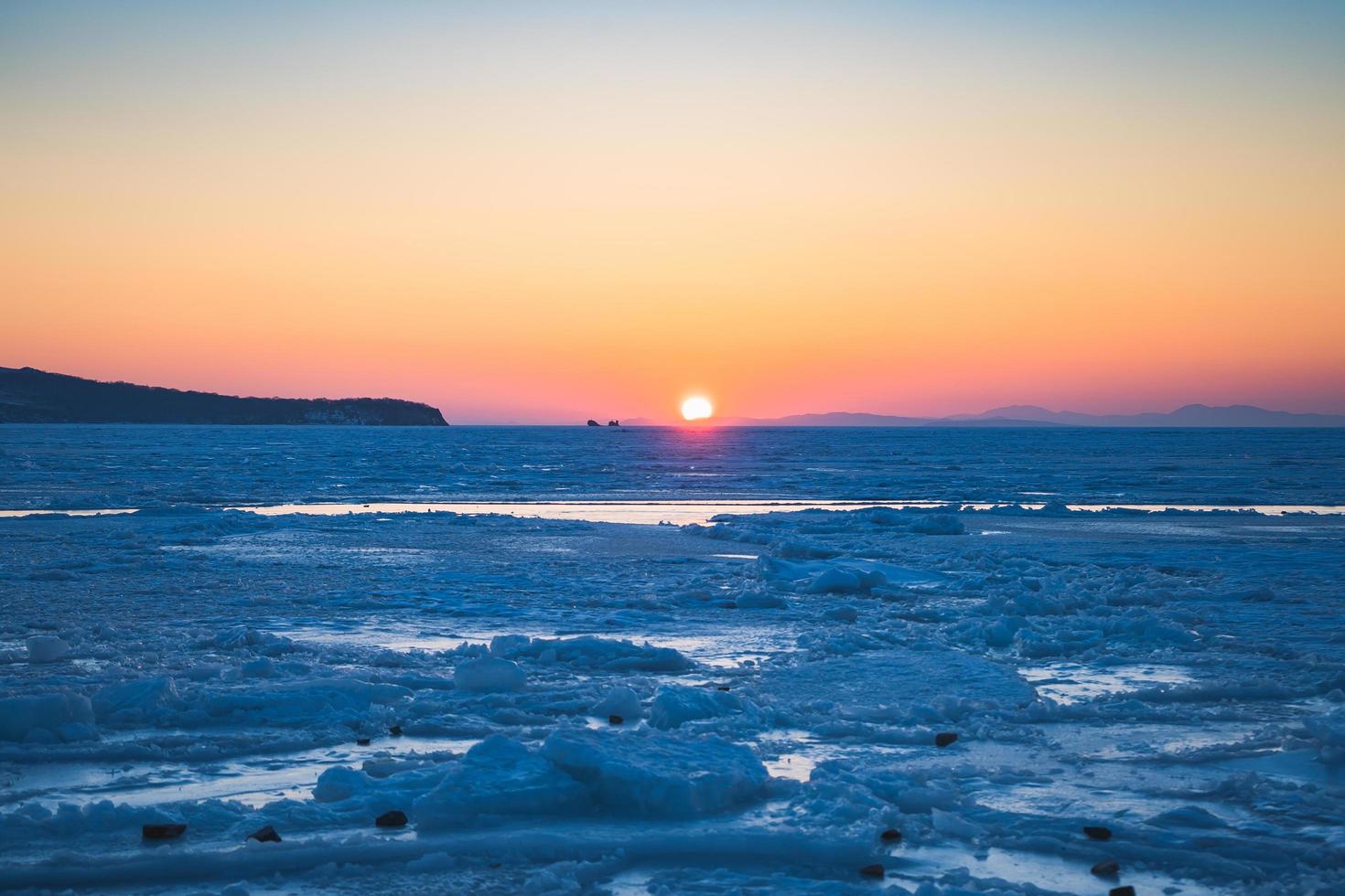 Seascape with sunset view over the icy surface in Vladivostok, Russia photo