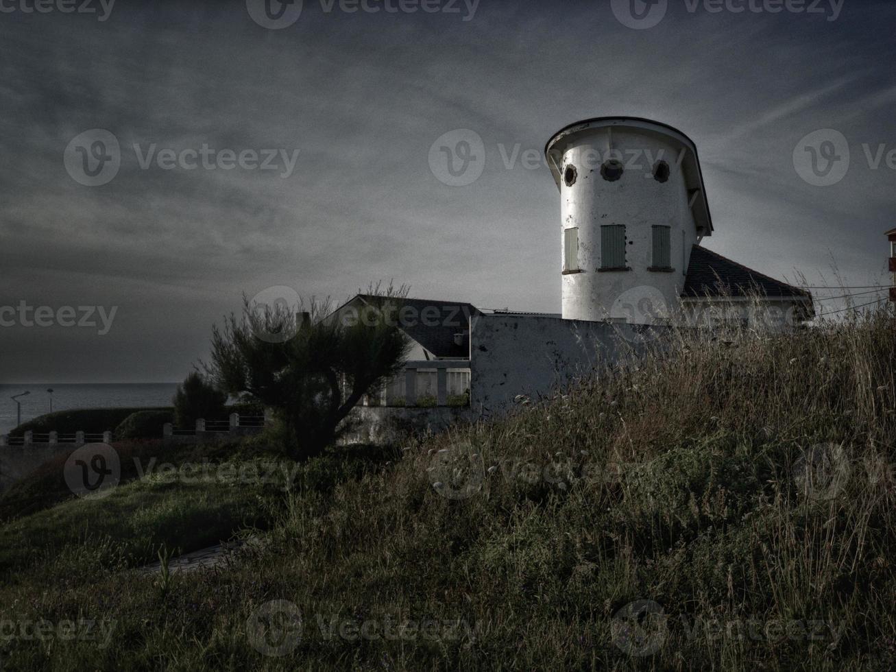 Rationalist house in a coastal town at sunset photo