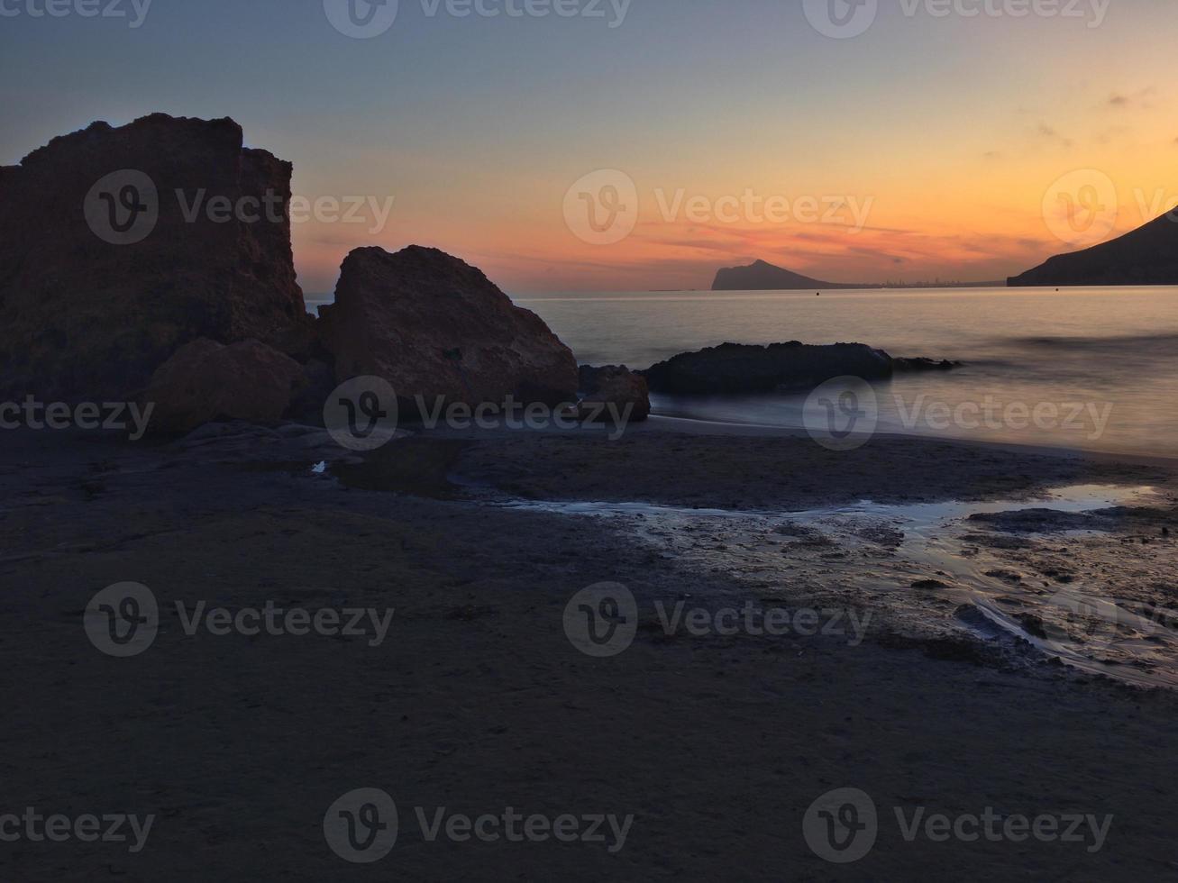 Mediterranean beach with no people at sunset in Calpe, Alicante photo