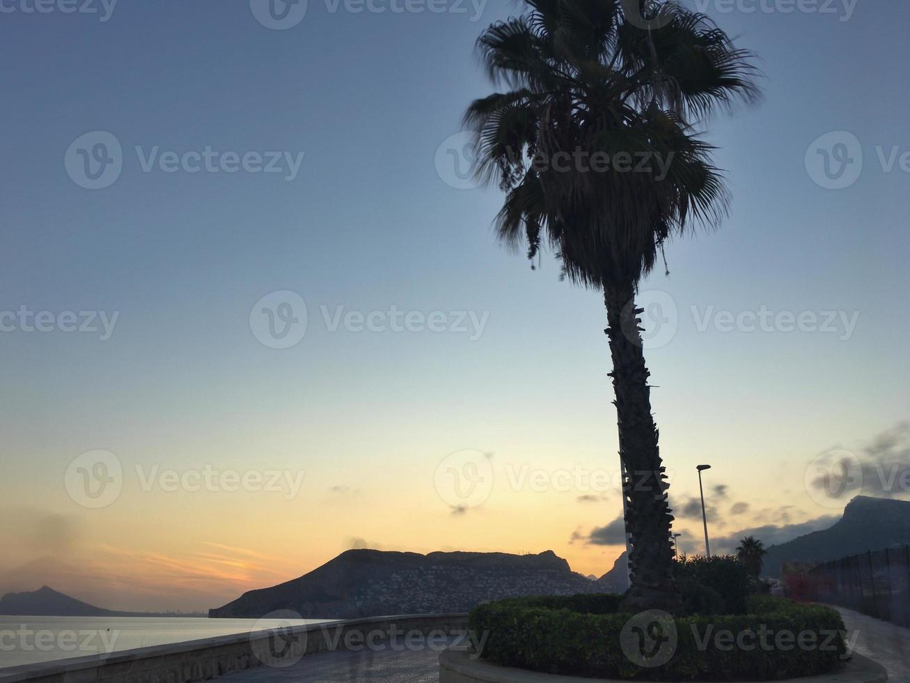 Mediterranean beach with no people at sunset in Calpe, Alicante photo
