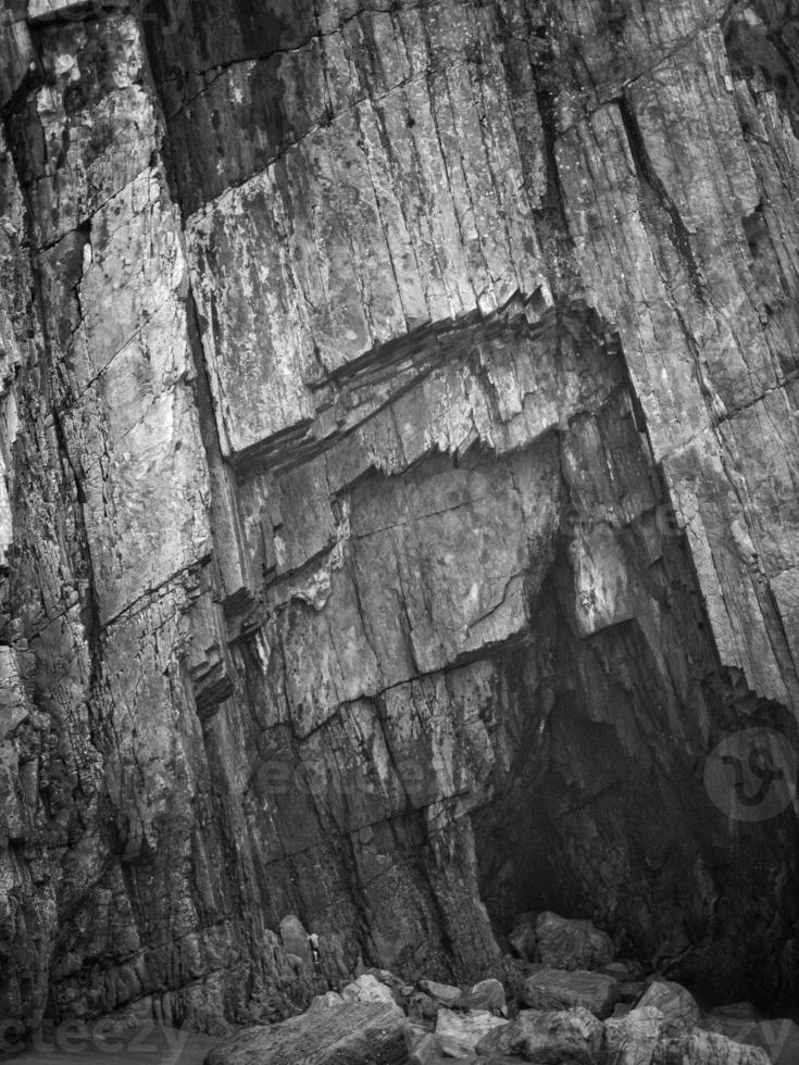 Rocks with straight edges at low tide of a beach on the Asturian coast photo