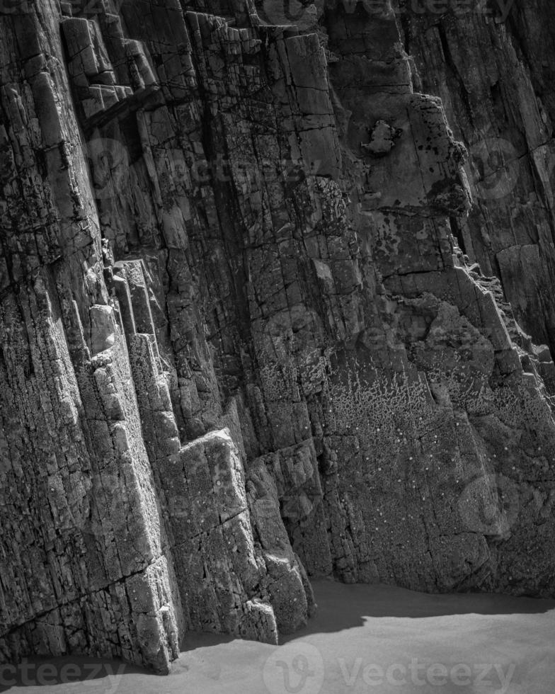 Rocks with straight edges at low tide of a beach on the Asturian coast photo