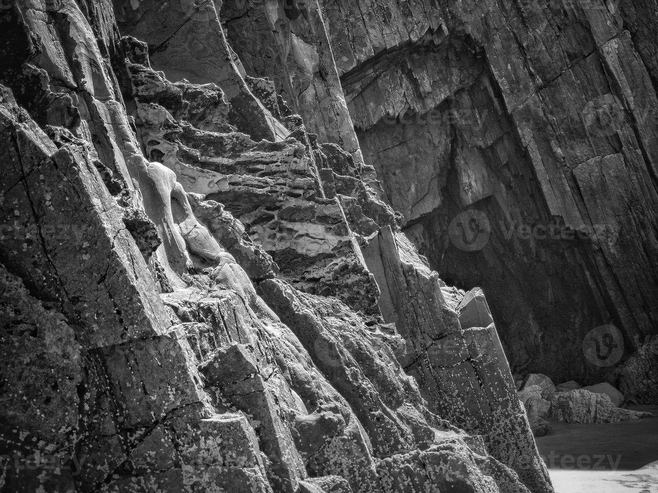 Rocks with straight edges at low tide of a beach on the Asturian coast photo