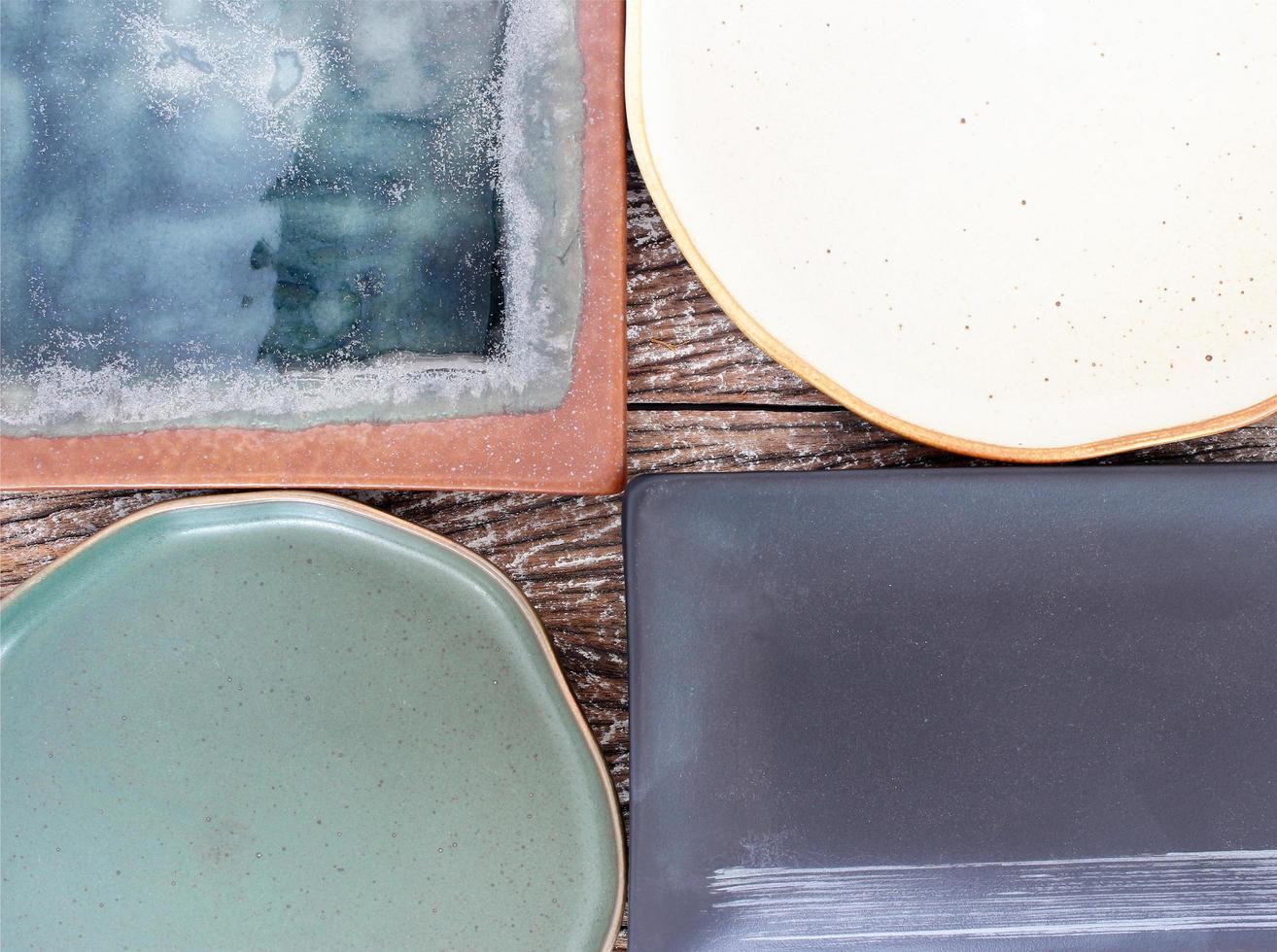 Top view of empty ceramic plates on a wood table background photo