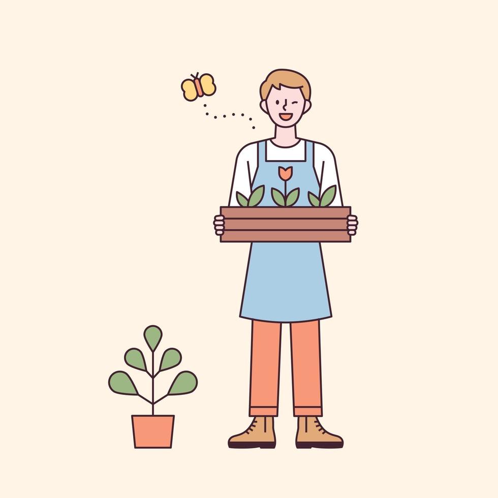 A man in an apron standing with a wooden box of flowers vector