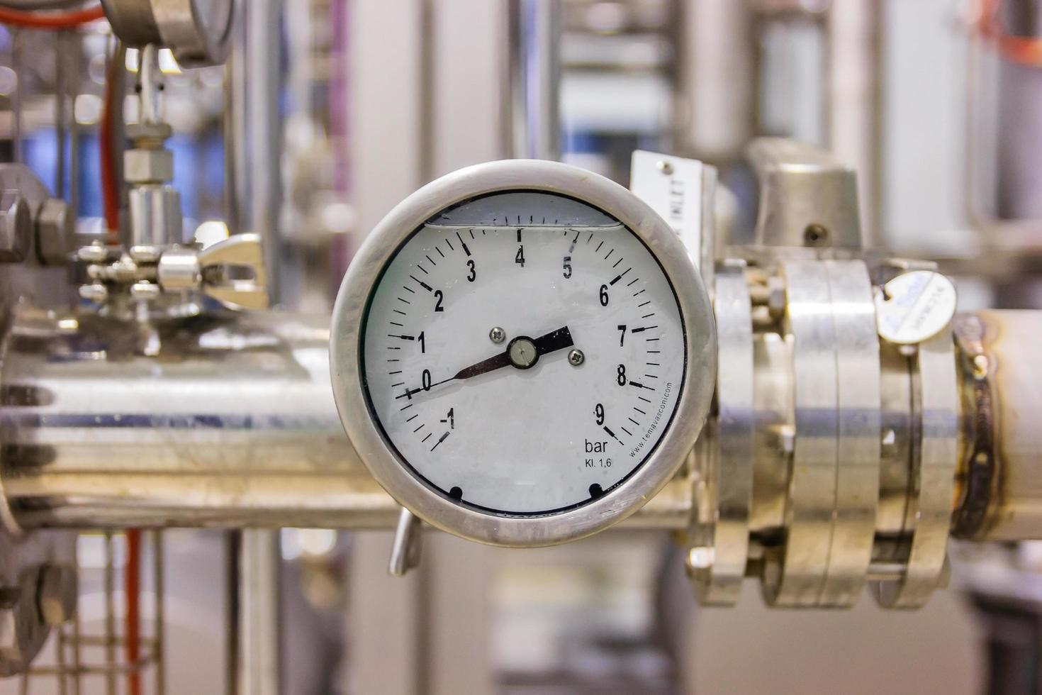 Close-up of pressure gauge, pipes and valves at pharmacy industry manufacture factory photo