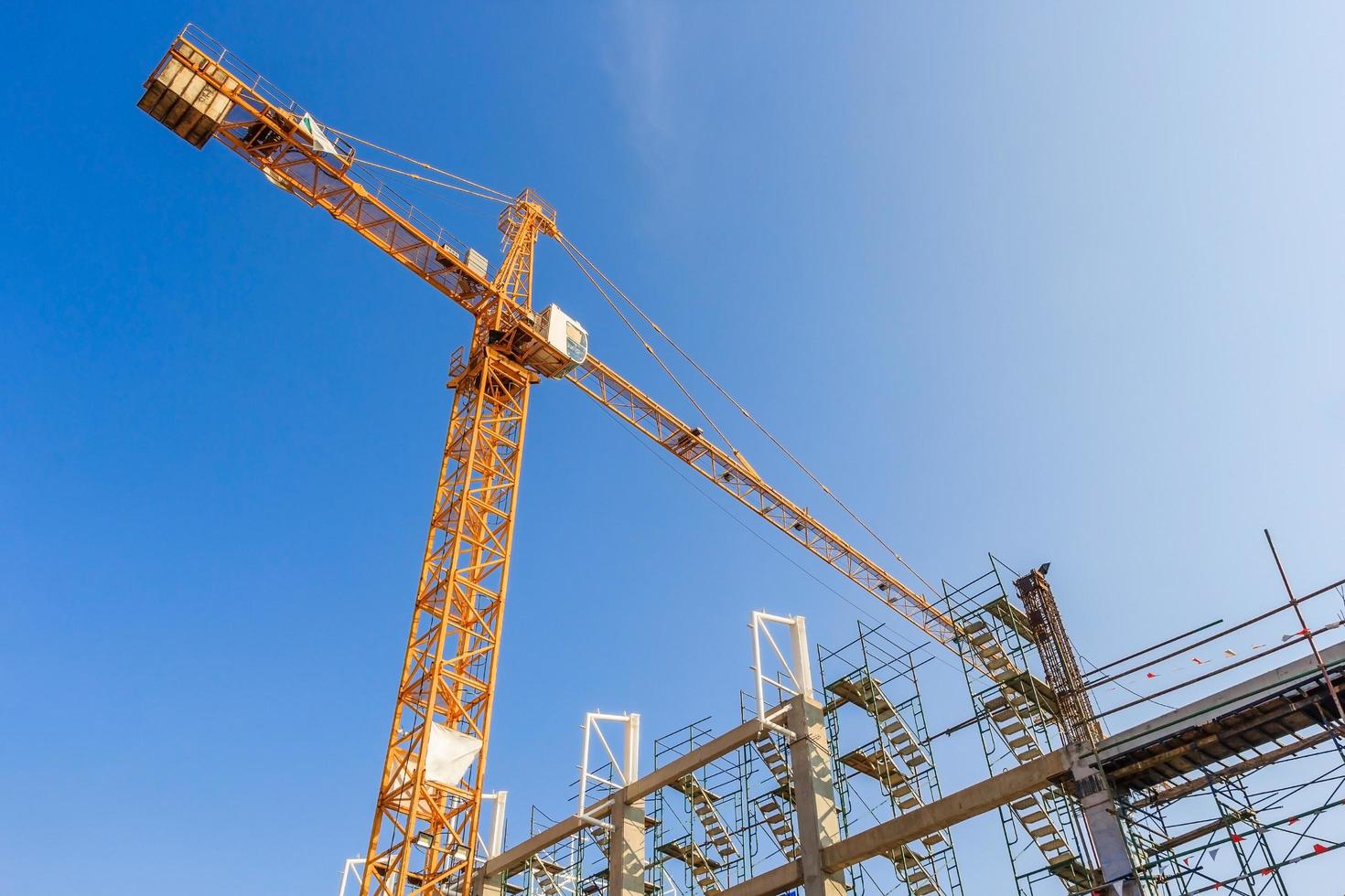 Industrial construction cranes and building in a beautiful blue sky background photo