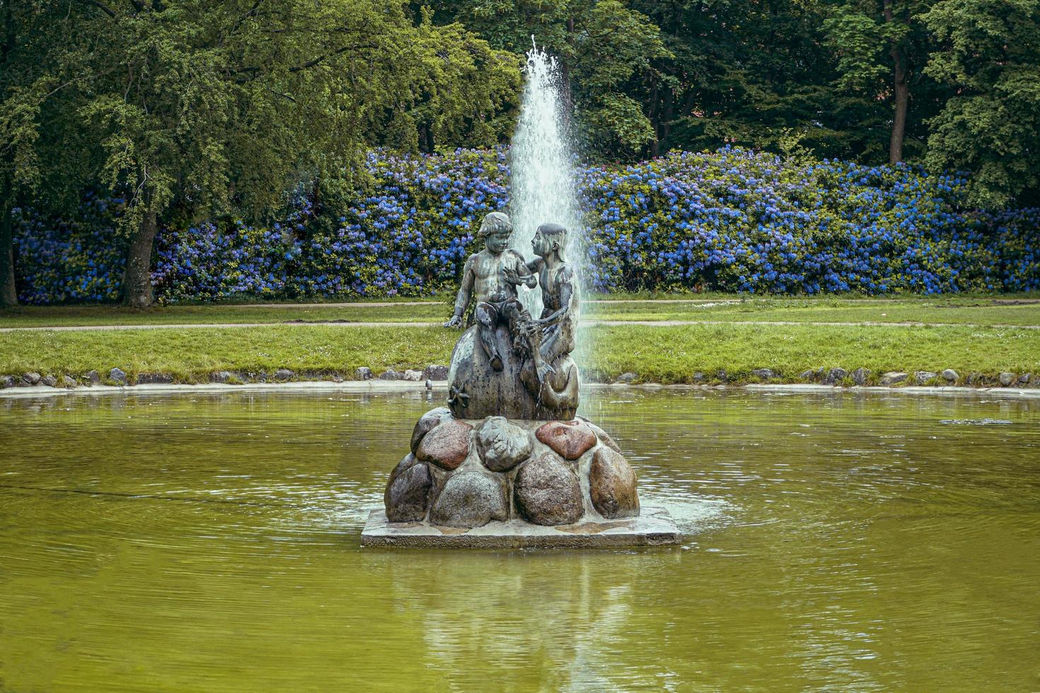 Daytime view of fountain in park photo