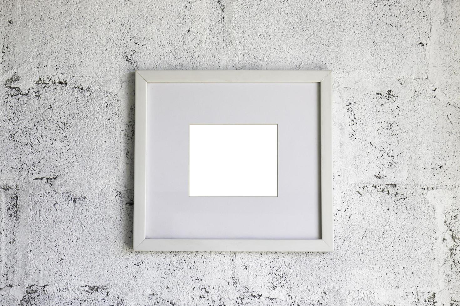 Empty picture frame on white wall photo