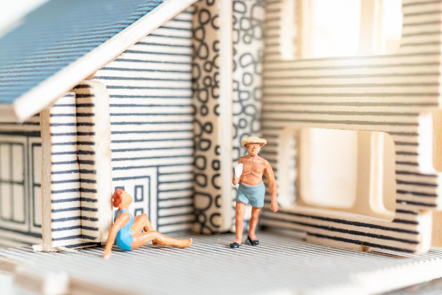 Miniature people staying at home doing self-quarantine to avoid coronavirus, stay home concept photo