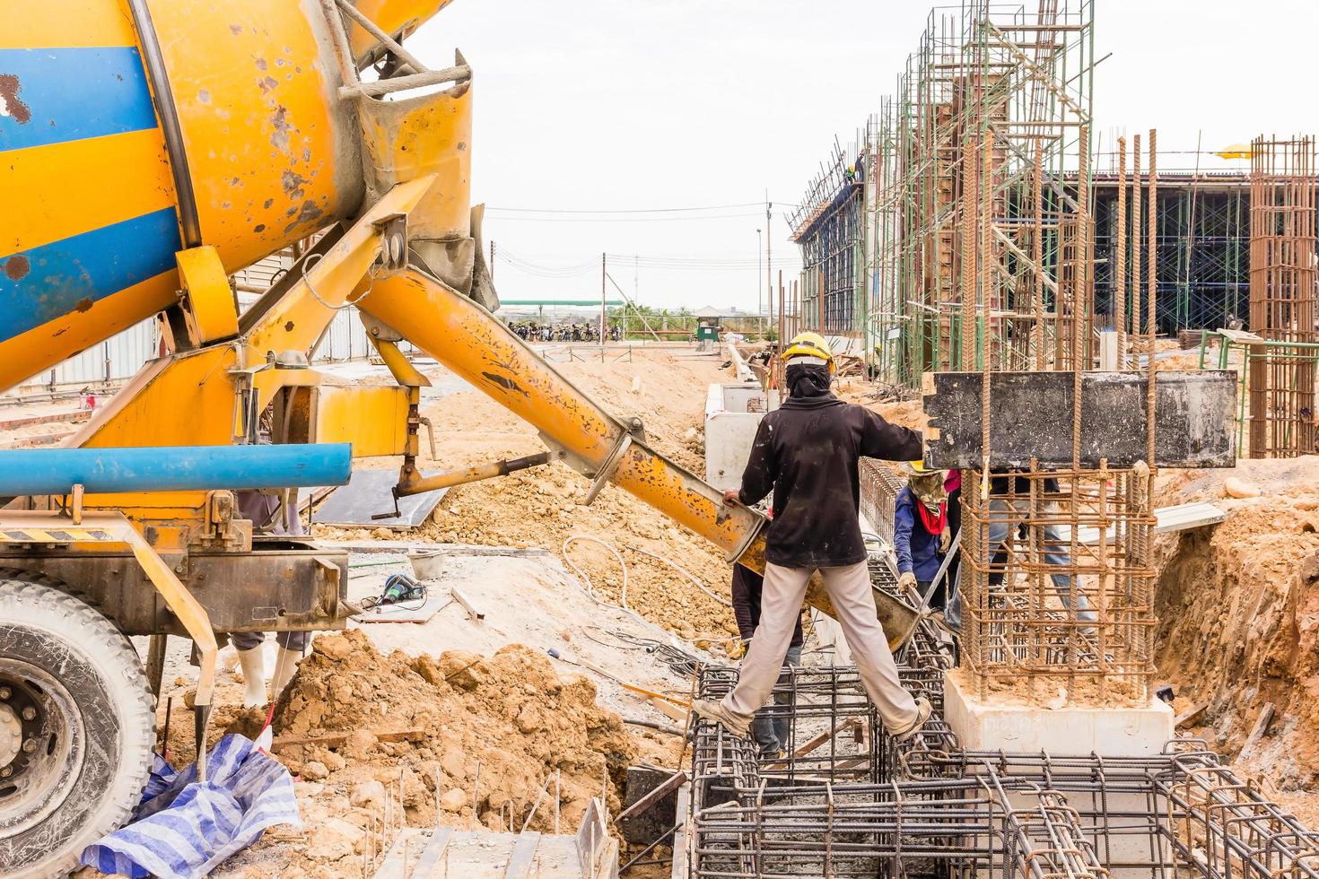 Concrete pouring during commercial concreting floors of buildings in construction site photo