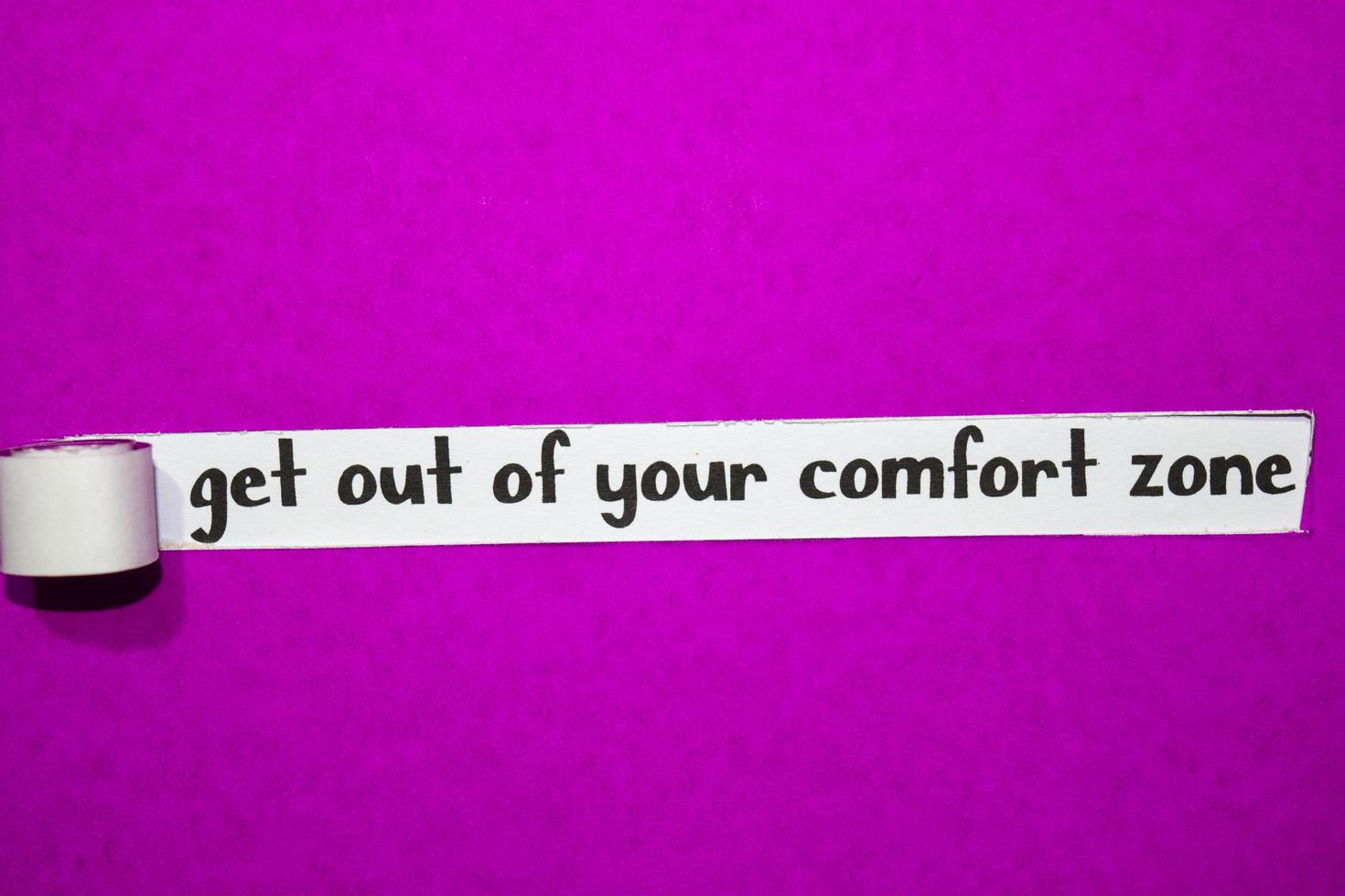 get out of your comfort zone text, Inspiration, Motivation and business concept on purple torn paper photo