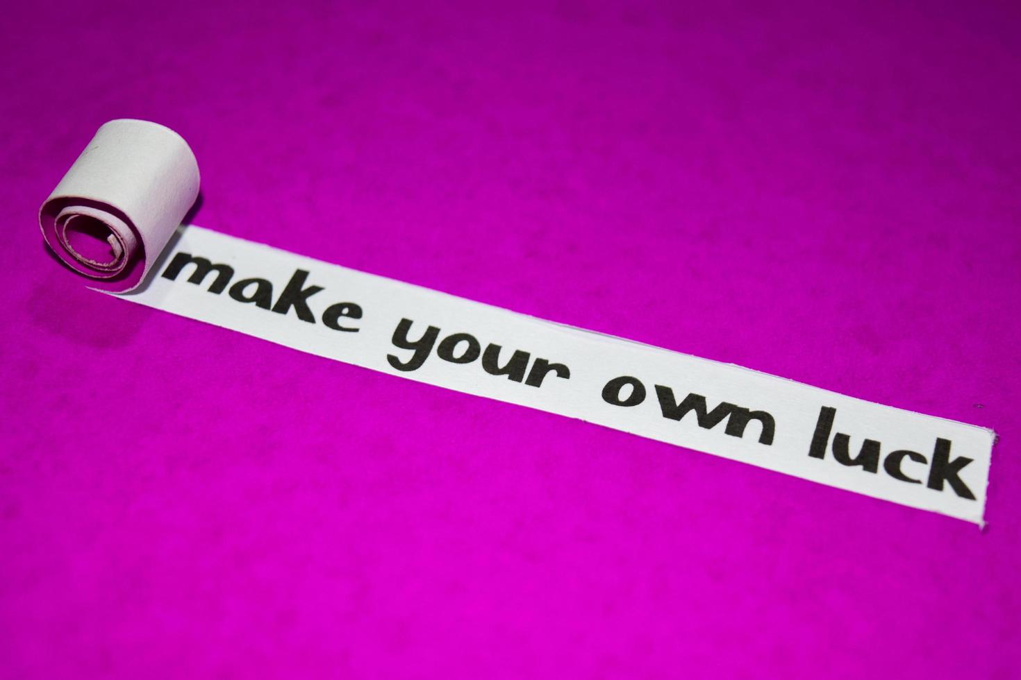 Make your own luck text, Inspiration, Motivation and business concept on purple torn paper photo