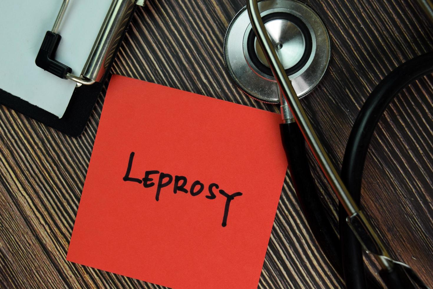 Leprosy written on a paperwork isolated on wooden table photo