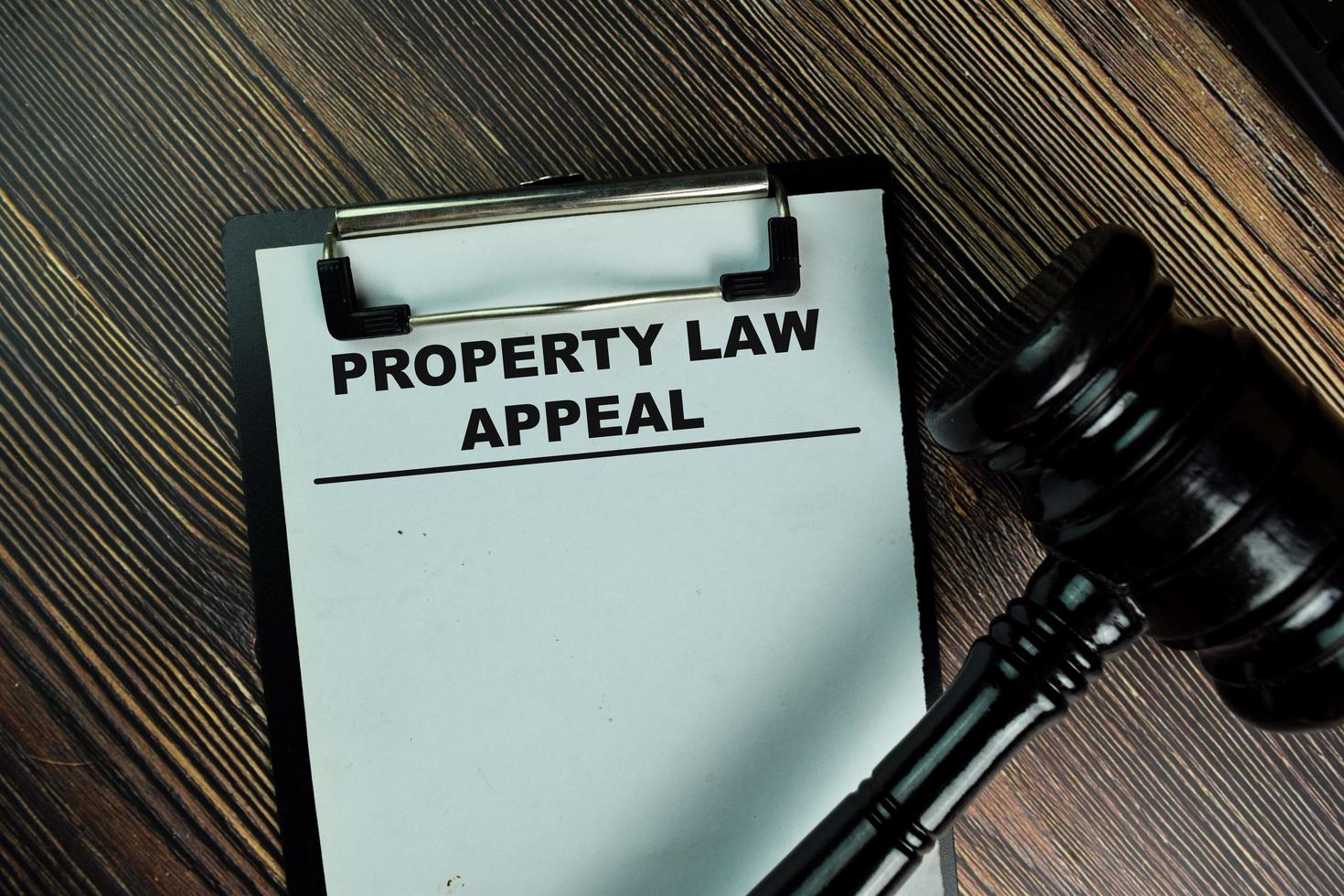 Property Law Appeal written on paperwork isolated on wooden table photo