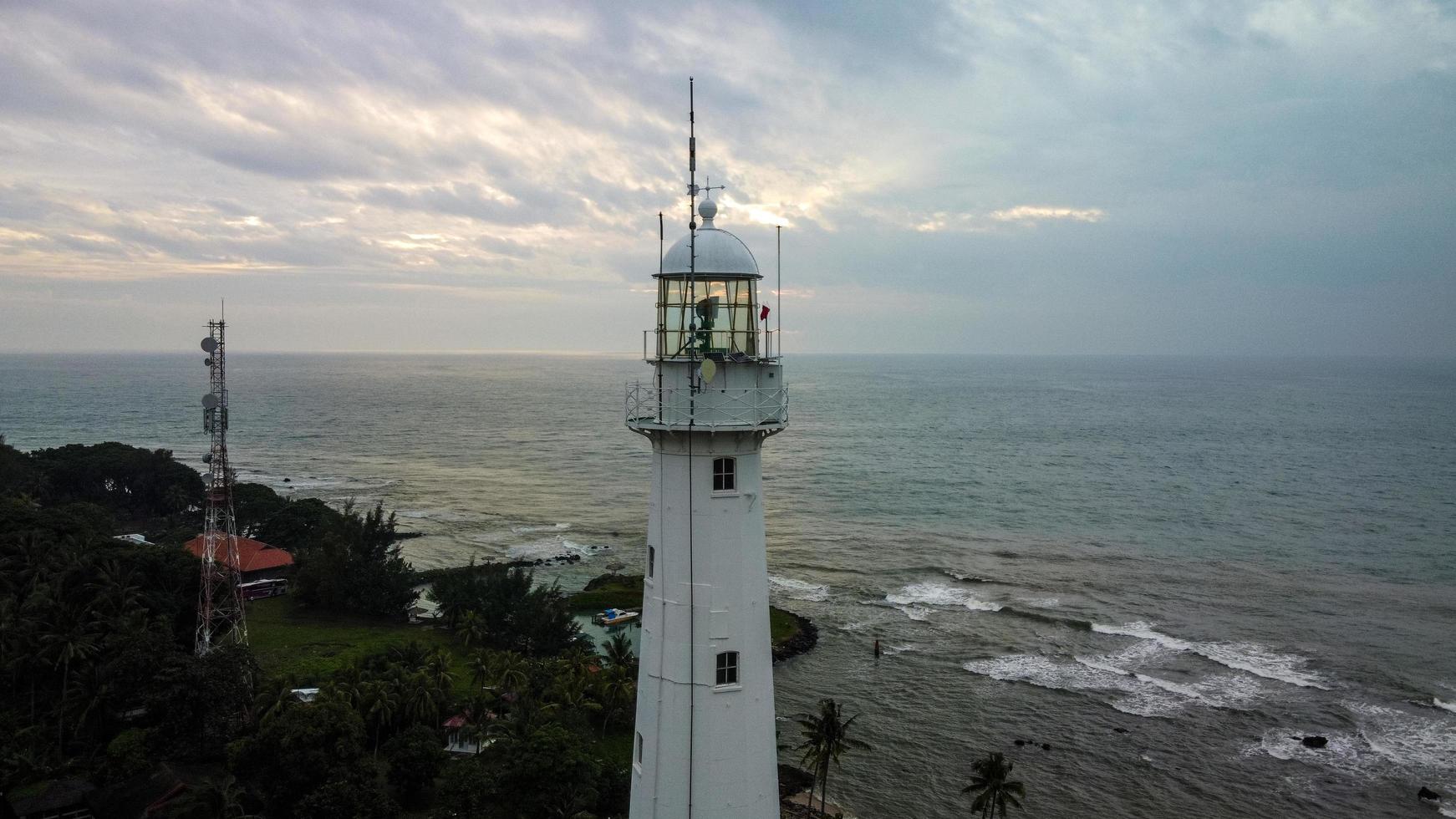 Banten, Indonesia 2021-- Aerial view of Lighthouse sea rock sunset landscape photo