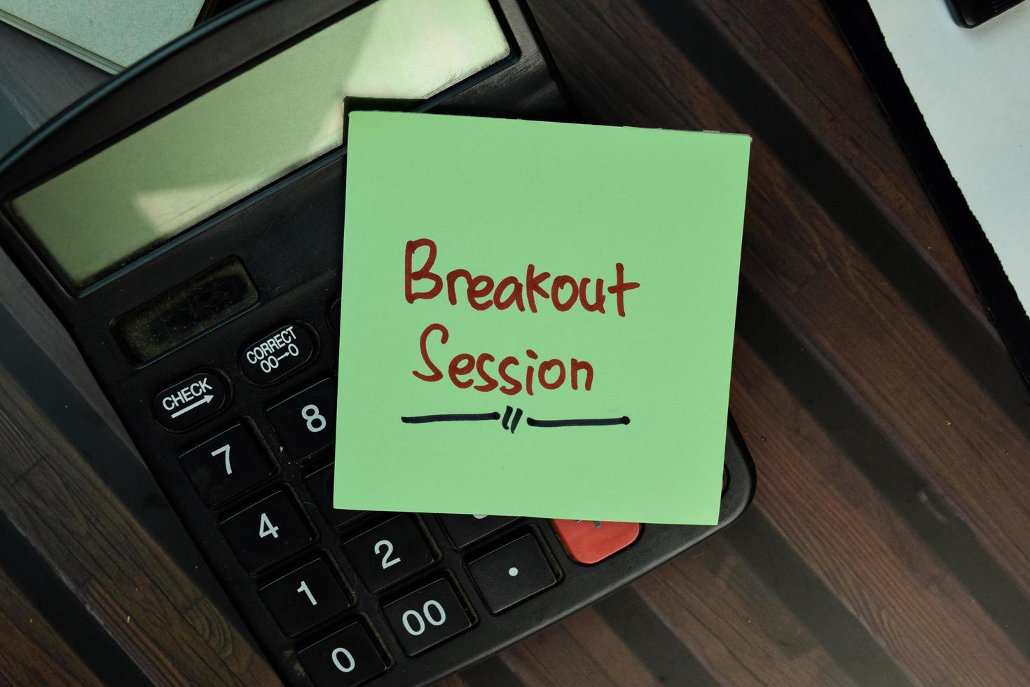 Breakout Session written on sticky note isolated on wooden table photo