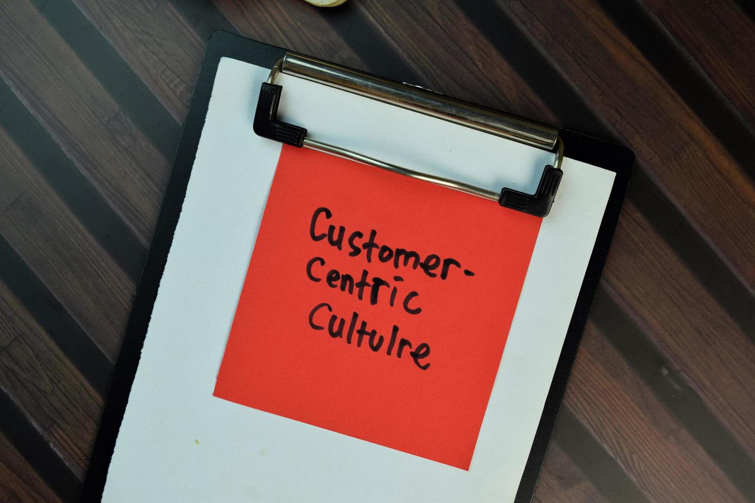 Customer Centric Culture written on sticky note isolated on wooden table photo