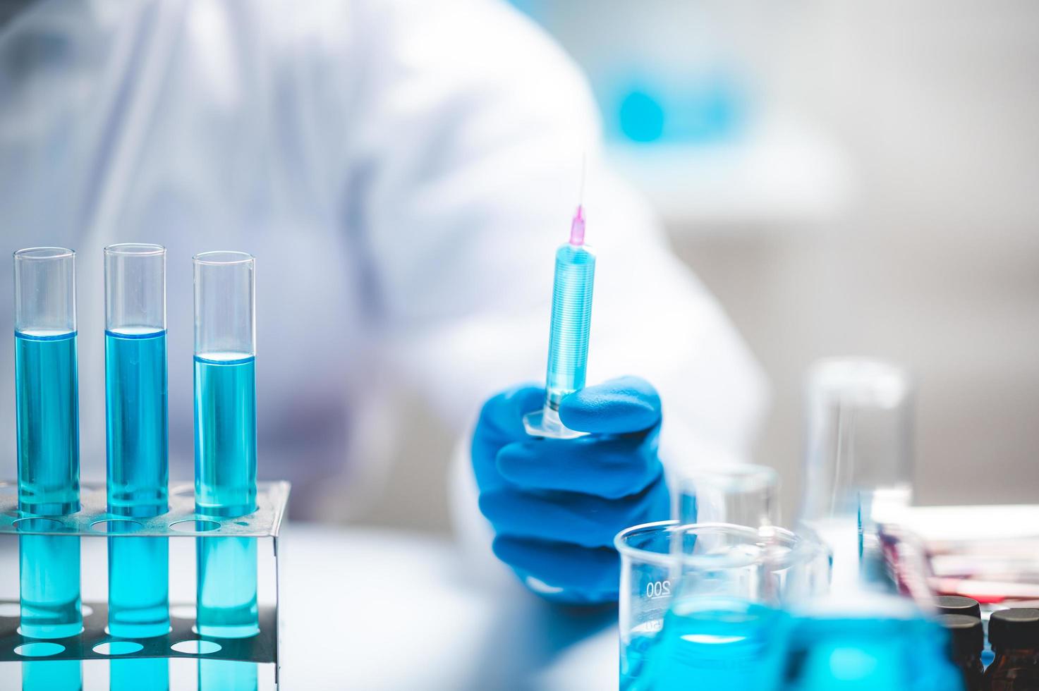 Researcher holding a syringe photo